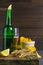 Dried salted tuna meat strips with beer, lemon and potato chips on dark wooden board. Snack on fish with beer. Front views, close-