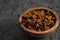 Dried seaberry buckthorn in olive bowl on terrazzo countertop with copy space