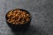 Dried seaberry buckthorn in olive bowl on terrazzo countertop with copy space