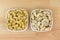 Dried and soaked Cashew nut seeds in white bowl on wooden background