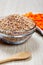 Dried spelt and carrots in a bowl on a table