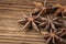 Dried star anise spice on vintage wooden board