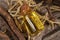 Dried sticks of licorice root and essential oil on table, closeup