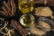 Dried sticks of licorice roots, powder and essential oil on black table