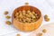 Dried sweet natural mulberry berries in the round wooden bowl  on light background in the kitchen.