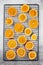 Dried thin translucent orange slices on pastry rack