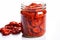 Dried tomatoes in a glass jar on a white background close up