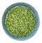 Dried uncooked green peas on a plate isolated