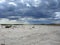 A dried-up riverbed of the salt lake desert the naked bottom of the reservoir in Kazakhstan with storm clouds nature landscape