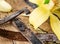 Dried vanilla fruits and vanilla orchid on wooden table