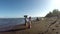 Drift wood obscure the view of fish vendor on the beach. tracking shot