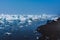 Drifting ice in the sea near the sandy coast. Ice in the sea near the beach