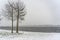 The drifting snow covers the surroundings of lake Zoetermeerse Plas in Zoetermeer