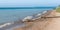 Driftwood on beach, kayaks in distance