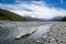Driftwood log in braided river of New Zealand