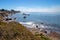 Driftwood log on Rugged and rocky Central California coastline at Cambria California USA