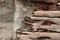 Driftwood with rusted bolts set against a concrete stone wall, vintage grunge background