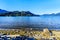 Driftwood on the shores of Pitt Lake with the Snow Capped Peaks of the Golden Ears Mountains