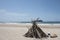 Driftwood structure on beach.