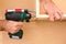 Drill driver whit screw on wooden background