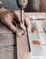 Drill a mill for a tree in the boring machine with a laser marking. Hands master drills a hole in a wooden bar