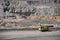 Drilling car and big yellow mining empty truck with dust transportation. Open pit mine industry