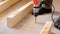 Drilling holes in the concrete floor of the house with a puncher drill for the installation of wooden floor logs. Construction and