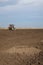 Drilling holes in field, preparing for tree planting