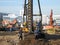 Drilling of wells under piles