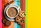 Drink with caffeine or cocoa with milk. Coffee on colorful positive background, top view. Cup of coffee with milk or