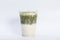 A drink called matcha green tea latte, green tea mixed with sweetened condensed milk served by put in takeaway plastic cup
