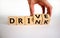 Drink or drive symbol. Male hand flips a wooden cube and changes the word `drink` to `drive`. Beautiful white background, copy