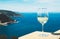 Drink glass white wine standing on background blue sea top view city coast yacht from observation deck, romantic lonely toast