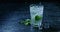 Drink with lime, mint and ice poured into a glass with splashes and spray. Slow motion 2k video shooted on 240 fps