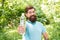 Drink Plenty Of Water. drinking water in forest outdoor with sunset nature on background. Bearded man with water bottle