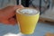 Drink scene of Hot Latt Coffee in yellow Cup on Brown wood Table at Coffee Cafe in Danang Vietnam