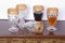 Drink, set of five gold rimmed glass goblets; photo on wooden background