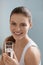 Drink water. Smiling woman holding fresh pure water in glass