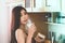 Drinking milk making woman beauty perfect body. Seductive Asian woman in lingerie is eating breakfast in kitchen