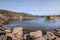 Drinking water dam in Frauenau in Bavarian Forest with outlet overflow in summer with little water filled to dry season, Germany