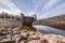 Drinking water dam in Frauenau in Bavarian Forest with outlet overflow in summer with little water filled to dry season, Germany