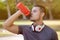 Drinking water runner young man running jogging sports training fitness workout