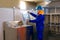 Drinking water treatment plant, factory worker inspect a plastic bottle, monitor cleanliness