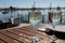 Drinking of white wine at farm cafe in oyster-farming village, with view on boats and water of Arcachon bay, Cap Ferret peninsula