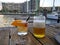 drinks alongside a waterfront view of a boat canal.