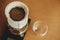 Drip coffee. Brewing aromatic fresh coffee in paper filter closeup in pour over on scale. Alternative coffee brewing v60 closeup.