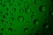 Dripped water on glass. Green abstract background