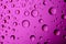 Dripped water on glass. Pink abstract background