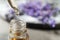 Dripping lavender essential oil into bottle. Space for text