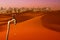 Dripping tap, desert and skyline of big city in the background